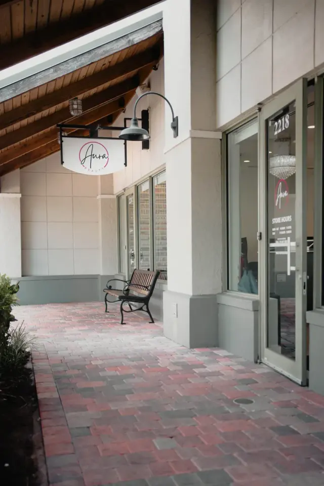 Aura Beauty storefront entrance and sign, Weston