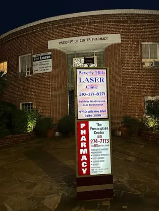 Beverly Hills Laser Clinic sign showing 9730 Wilshire Boulevard, Suite 205B, outside its building.