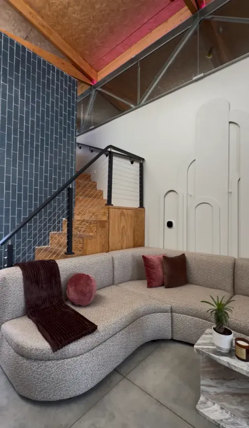 Curved sofa and seating area inside enforma’s Venice studio.
