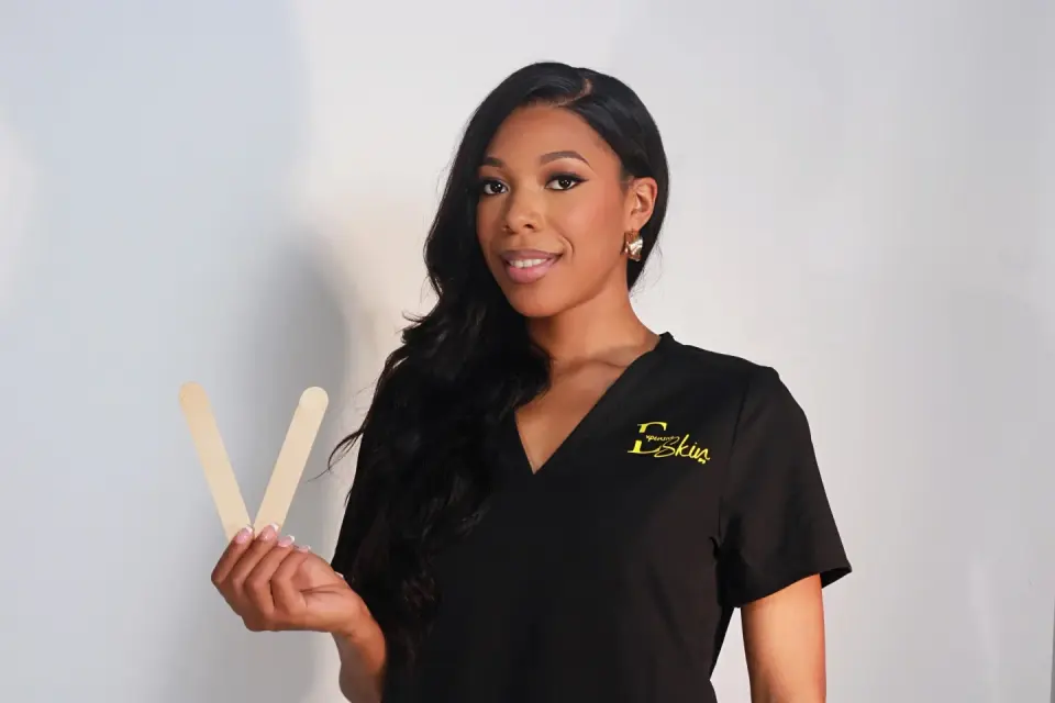 Esthetician at Expensive Skin Spa holding waxing sticks, College Park