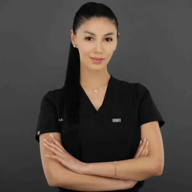 KAO Aesthetics team member Chrissey Q. in black clinic scrubs.