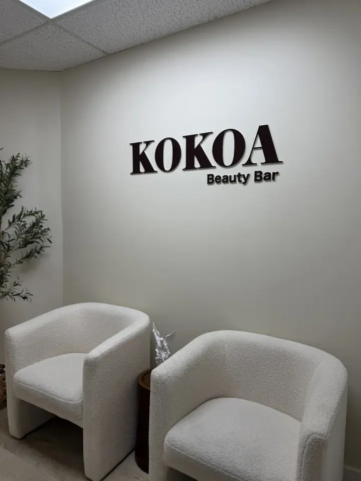 Waiting area with branded wall sign at Kokoa Beauty Bar, Coral Springs