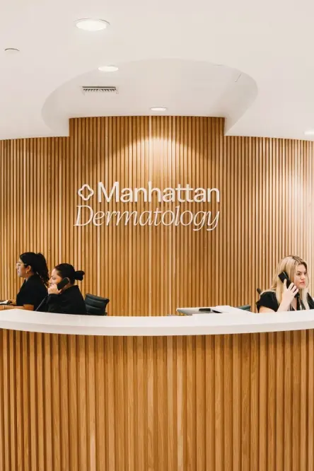 Reception desk with Manhattan Dermatology signage in Manhattan Beach.