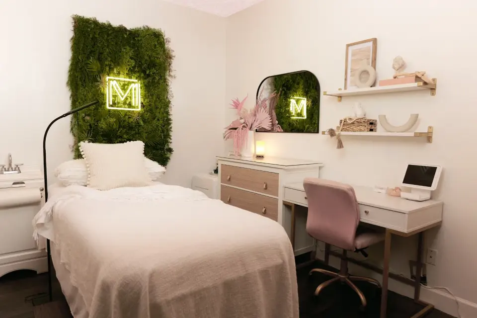 Treatment suite with neon M sign at Michella Minotti, Pembroke Pines