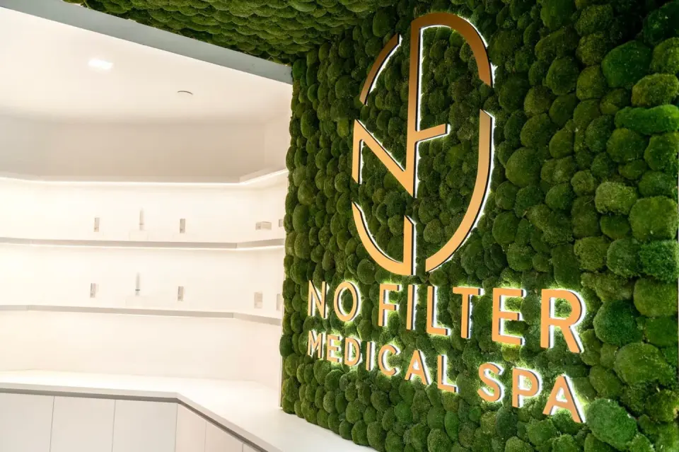 Moss-wall logo feature inside No Filter Medical Spa, Brickell
