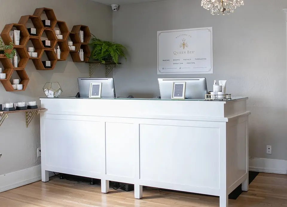 Reception desk and honeycomb shelving at Queen Bee Culver City
