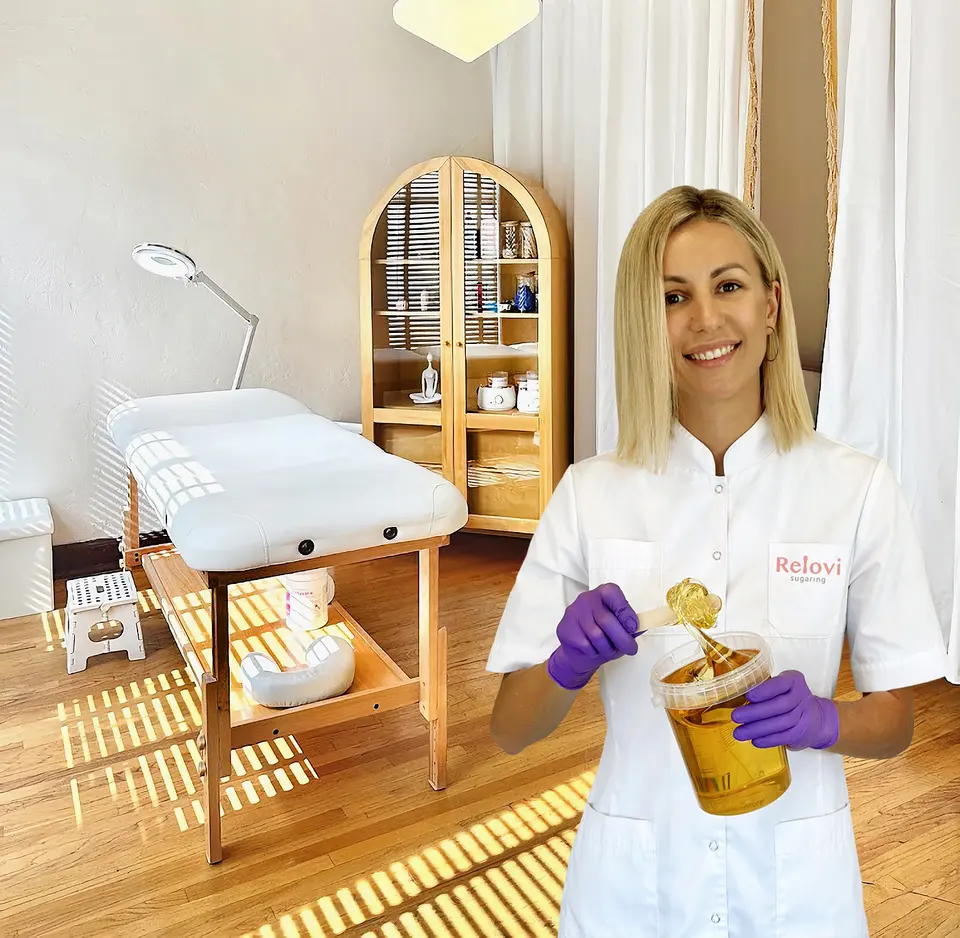 Olga with sugaring supplies beside the studio treatment bed