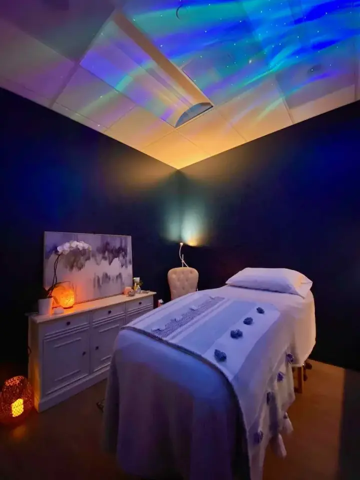 Treatment room at Sisu Skin Therapy with a treatment bed and ambient ceiling lights