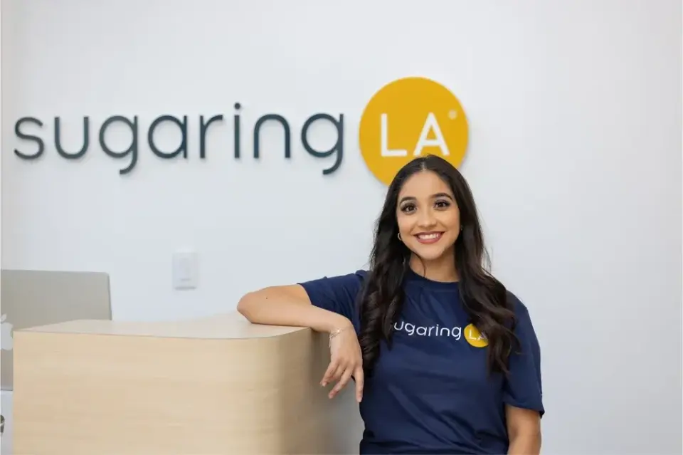 Staff member at sugaringLA Plantation reception desk
