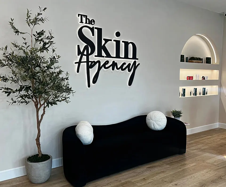 The Skin Agency Granada Hills waiting area with clinic wall sign