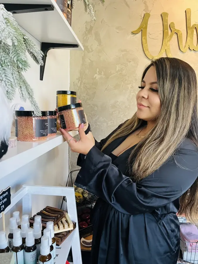 Urban Sugar Salon operator pictured beside the studio’s product display