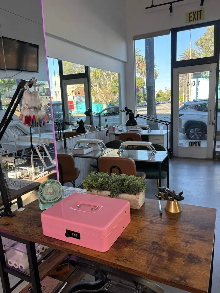 Via Venice’s interior with manicure stations and the Unit 104 glass entrance