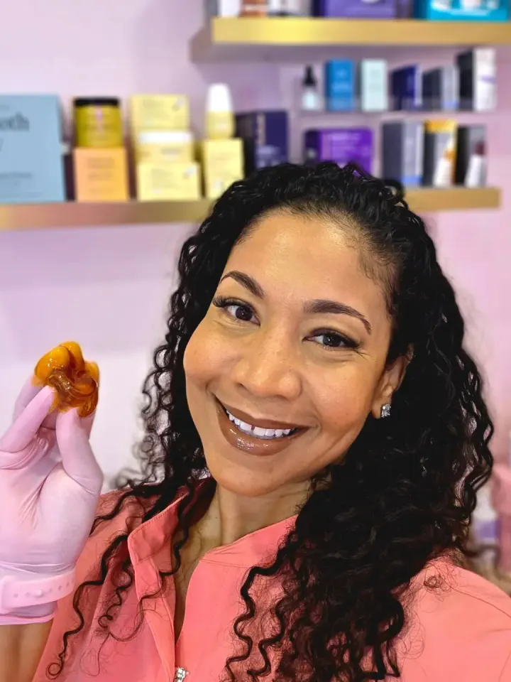 Esthetician holding sugar wax inside Xo Rituals Skincare & Aesthetics, Cutler Bay